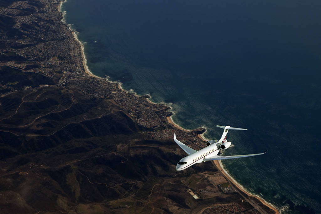 A NetJets plane flies over a golf course